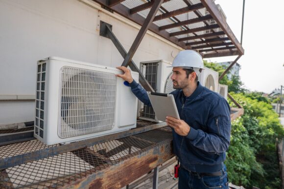 Air conditioner technician checking air conditioner operation.