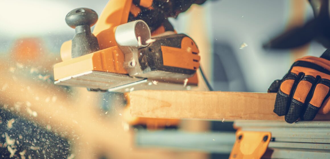 Carpenter with Corded Planer