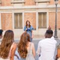 Man asking a question to a tour guide in a square