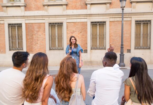 Man asking a question to a tour guide in a square