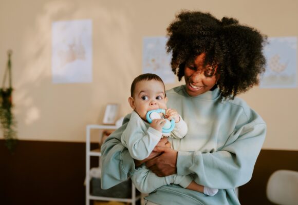 Mother Holding her Kid in Nursery